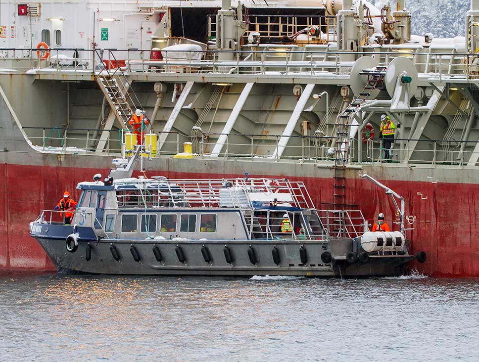 Personnel transfer vessel alongside a freighter